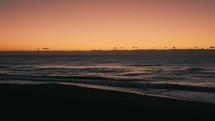 Orange sky and calm ocean at sunrise