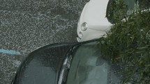 A car, flashing its headlights during a hailstorm