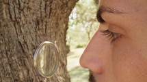 Agronomist looking at the trunk of an olive tree with magnifiying glass
