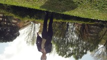 Upside down view of a woman running and jumping.