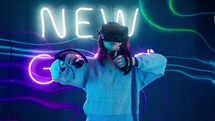 Woman moving her arms around as she plays a virtual reality game.