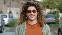 smiling young man with sunglasses outdoors 