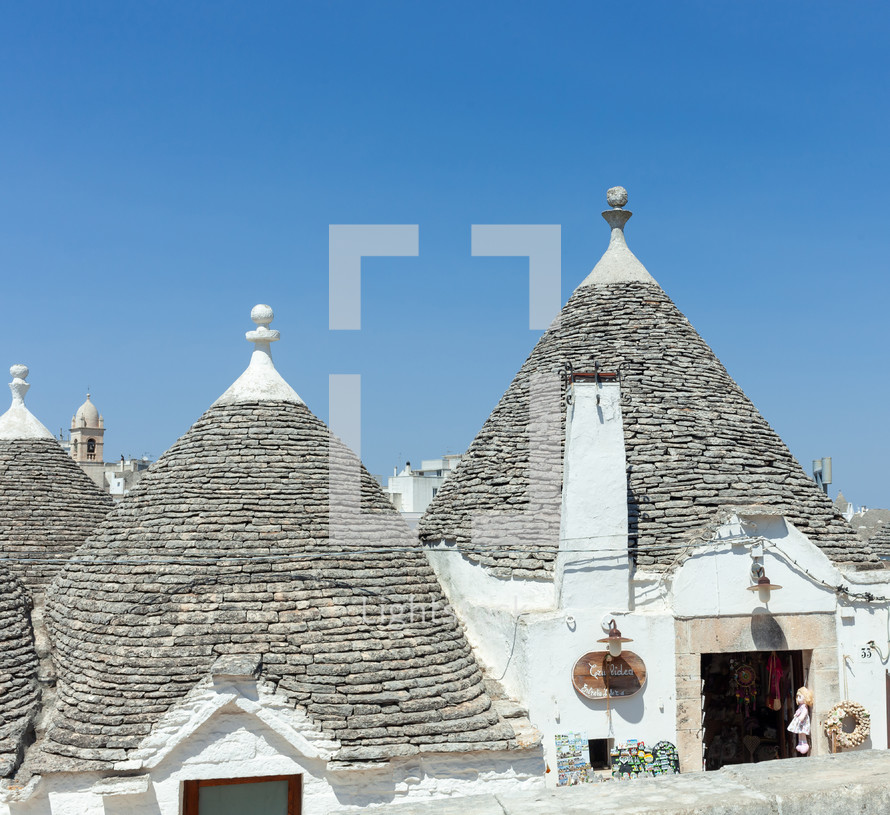 Traditional trulli houses with conical roofs made of stone, creating a unique and historical architectural landscape in alberobello, puglia