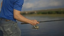 man casting a fishing pole 