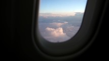 Corfu island, Greece - 2023.07.01 - 09: Beautiful clouds and sky as seen through window of an aircraft on summer day