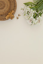 flowers, basket and earrings on a white background 