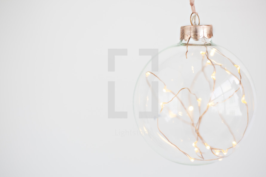fairy lights in a clear Christmas ornament 
