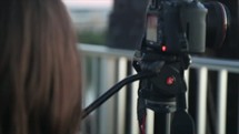 teen girl with a camera on a bridge 