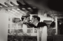 reflection of a bride and groom kissing