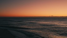 Orange sky and ocean before sunrise