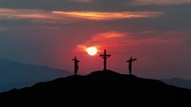 "Silhouettes of three crosses on top of a hill at sunset. 
Concept of the Crucifixion of Christ."
