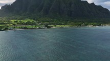 Cinematic aerial dreamy view of beautiful Hawaii coast Kualoa Beach.