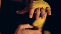a man wrapping his hands for boxing