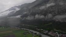 Drone journey unveils a hidden mountain village blanketed in fog in the heart of the Dolomites