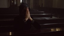 Religious woman praying in cathedral church. 
