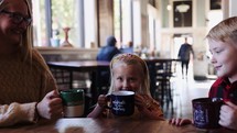 Mom Boy And Girl Drinking In Coffee Shop Cheers Small Town Family