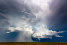 Microburst Of Hail Falling From A Huge Storm Cloud Over Fields