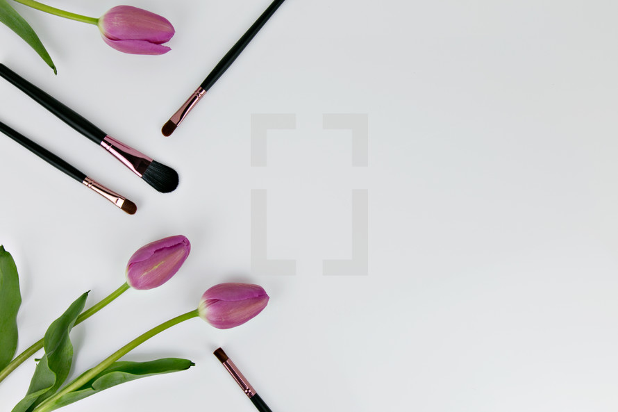 makeup brushes and pink tulips 