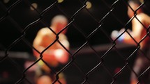 MMA - Cage Close Up with Fighters Fighting In The Background