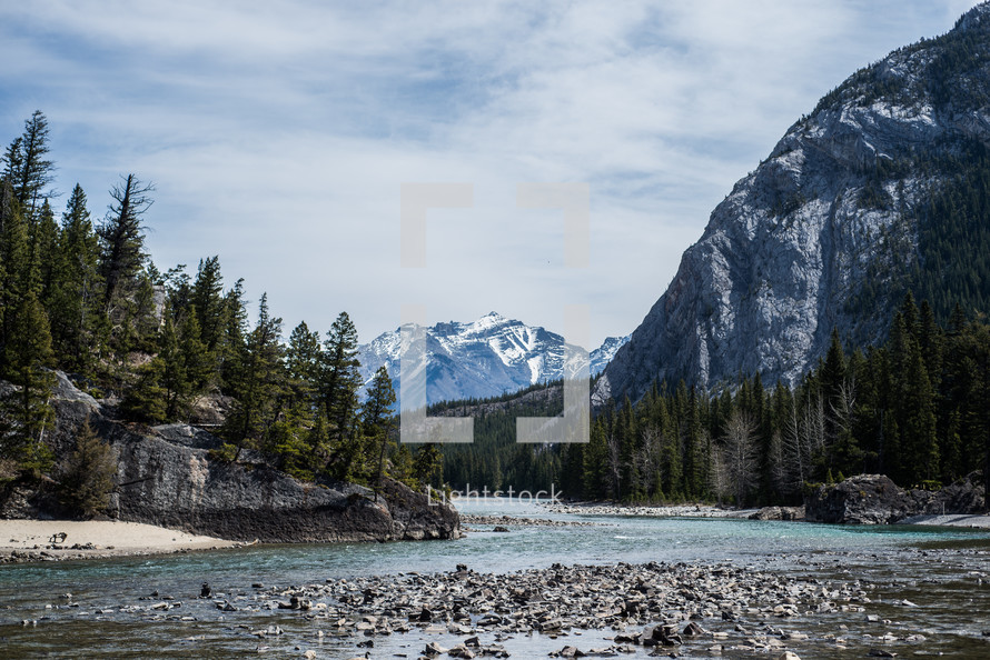 river, riverbanks, trees, forest, snow capped, mountains, outdoors, nature, water, sky, stones 