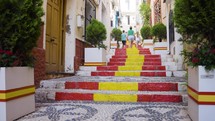 Family Walking Up Stairs Painted In Spain Colours In Calp Old Town