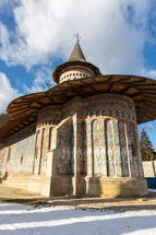 Low Angle shot of the old painted medieval Voronet Monastery, famous for the blue shade of vornet.