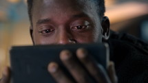 a man looking at a phone screen 