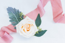 rose and pink ribbon on a wedding cake 