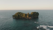 Aerial view showing tropical green island in Caribbean Sea during sunset. Punta Mona,Costa Rica	