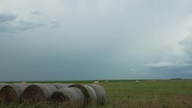 Farmland landscape with distant thunderstorm in rural America.