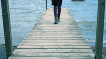 a woman walking on a dock 