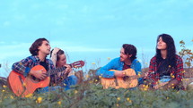 group singing and playing music outdoors 