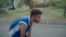Young Basketball Player Dribbling on Outdoor Court
