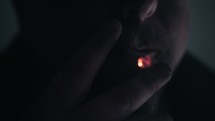 Drug addict smoking marijuana, drugs or cigarette blows smoke out of his mouth in slow motion.