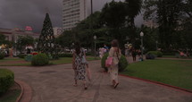 Women walking through park in south america wearing masks