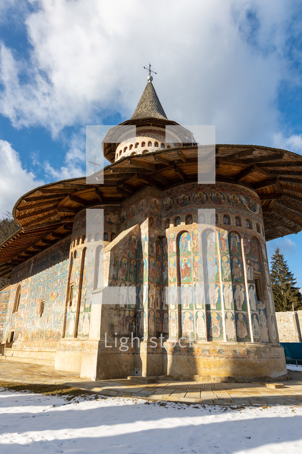 Low Angle shot of the old painted medieval Voronet Monastery, famous for the blue shade of vornet.