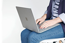 a woman with a laptop computer in her lap 