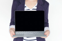 a woman holding a laptop computer 
