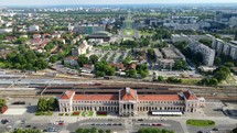 Aerial shot drone hovers over train station facing south in Zagreb, Croatia