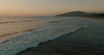 Aerial Drone shot of Sunset Beach With Surfers Riding Ocean Waves In Guanacaste, Costa Rica.