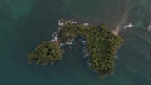 Top View Of The Island Of Punta Mona Amidst The Blue Water Of Caribbean Sea In Costa Rica. aerial	