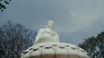 Panorama of a large Buddha statue located in the middle of the forest. Static shot