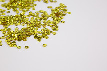 gold sequins on a white background 