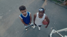 High Angle View of Two Basketball Players Posing with Ghetto Blaster and Ball
