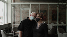 senior couple at a restaurant wearing face masks 