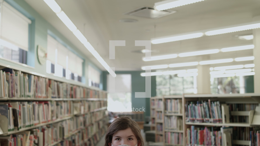 girl at a library wearing a face mask 