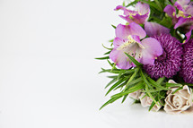 purple flower arrangement on white 