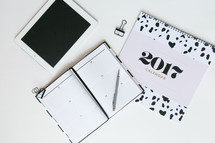 2017 calendar, planner, tablet, pen, and clips on a desk 
