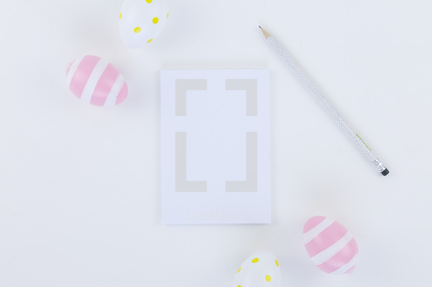 Easter eggs, pencil, and notepad 