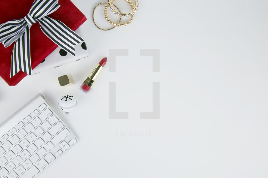lipstick, computer keyboard, desk, home office,, gift, bells, present, white background, Christmas, bows, back, earrings, gold, feminine, makeup 